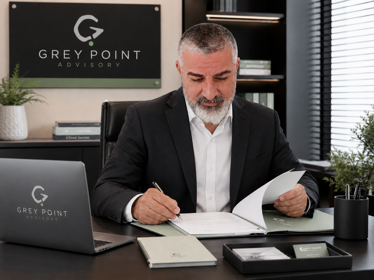 Elvis Sehovic, founder of Grey Point Advisory, reviewing business documents